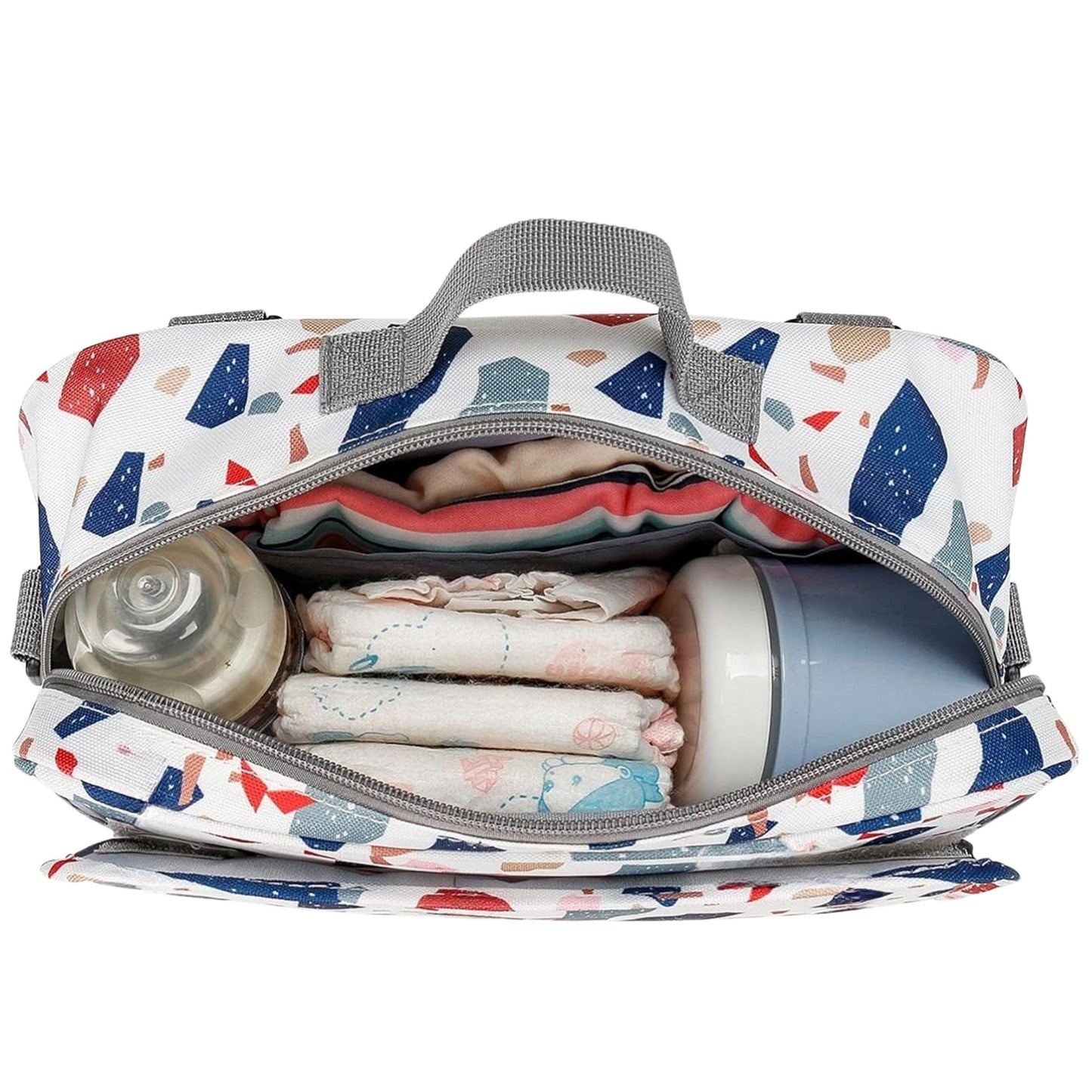 Intérieur du sac a langer montrant l'organisation pratique avec biberon, couches et accessoires