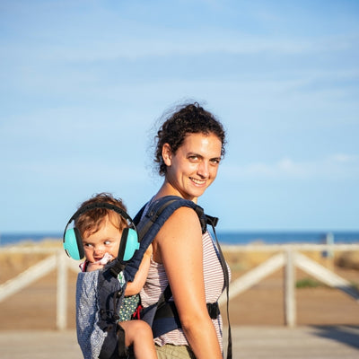 Casque antibruit bébé vert offrant une protection sonore optimale, idéal pour les sorties à la plage avec CalmProtect