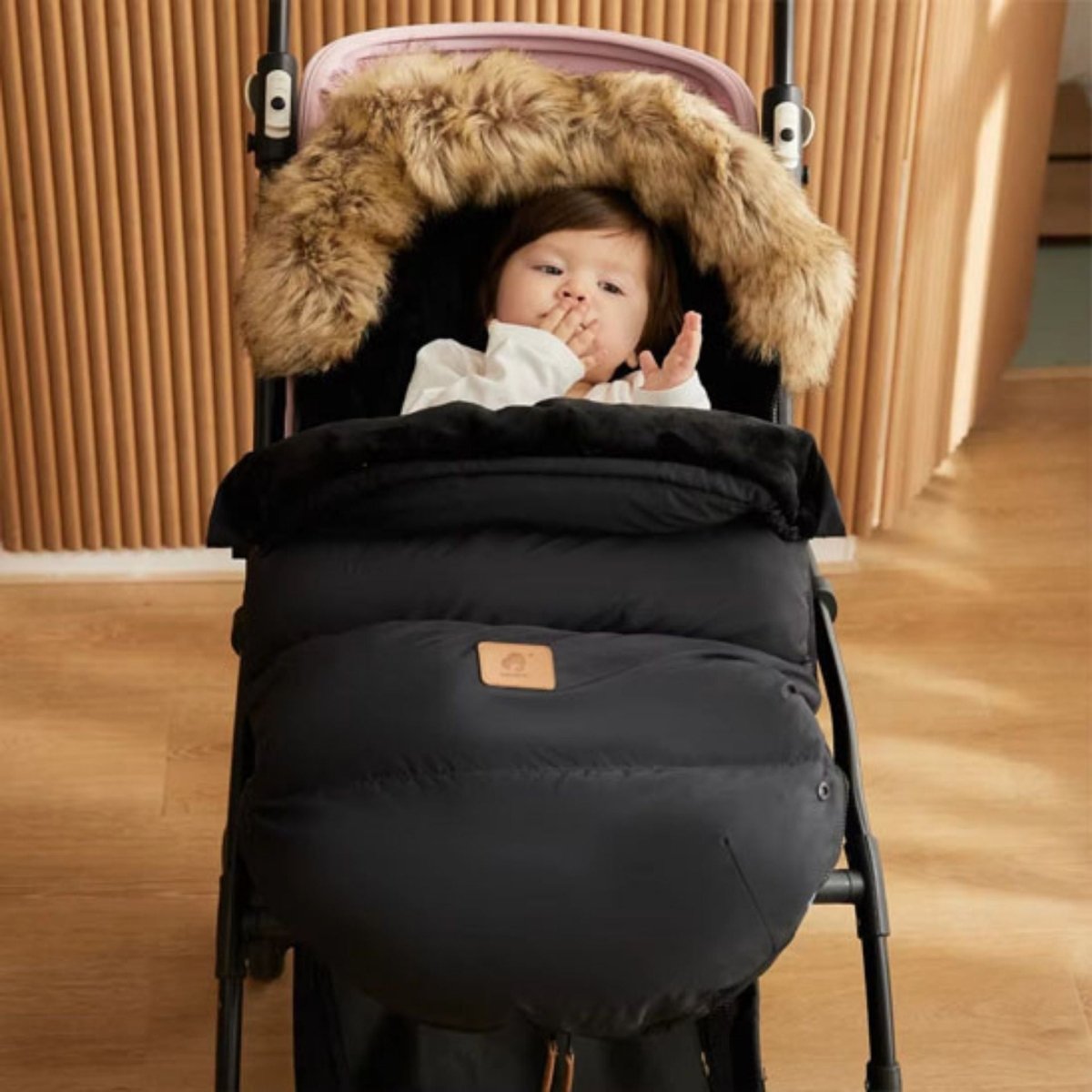 chanceliere bebe noire avec capuche épaisse, bébé en tenue blanche, photo prise en intérieur