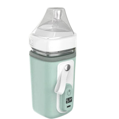 Chauffe biberon nomade vert menthe pâle avec sangle blanche et température affichée à 54°C