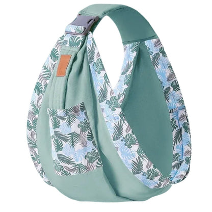 echarpe de portage vert menthe présentée vide, tissu uni vert clair avec bretelles et poche à imprimé feuillage bleu et vert