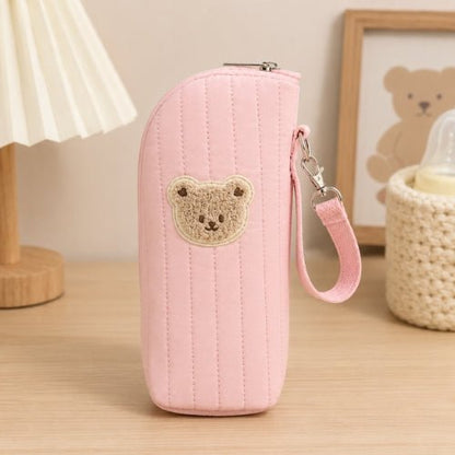 Étui matelassé pour biberon rose avec écusson ourson, sangle amovible et fermeture zip
