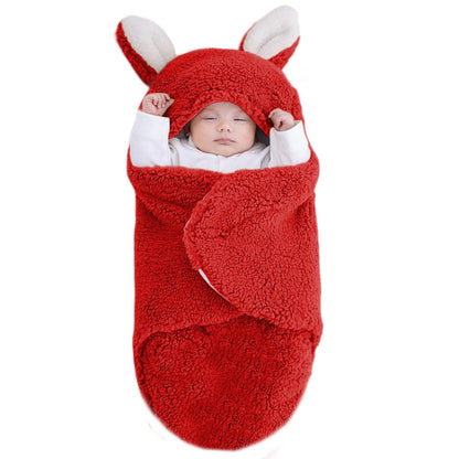 Nid d ange bebe rouge avec bébé endormi seul, bien installé dans un cocon douillet