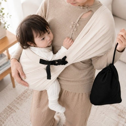 Porte-bébé à une épaule beige avec boucle réglable et pochette de rangement noire en intérieur