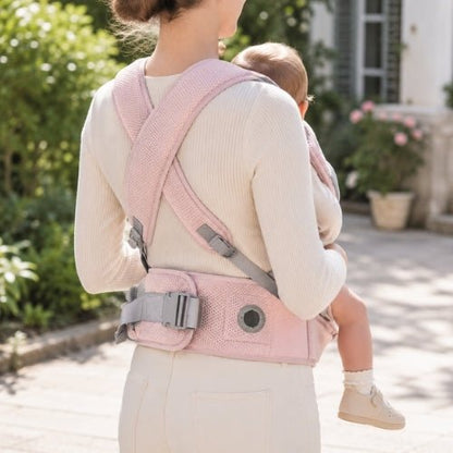 Porte-bébé avec siège détachable rose, vue arrière avec bretelles croisées et molette de réglage visible
