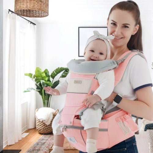 Porte bebe evolutif rose porté par une maman avec bébé en position face à face
