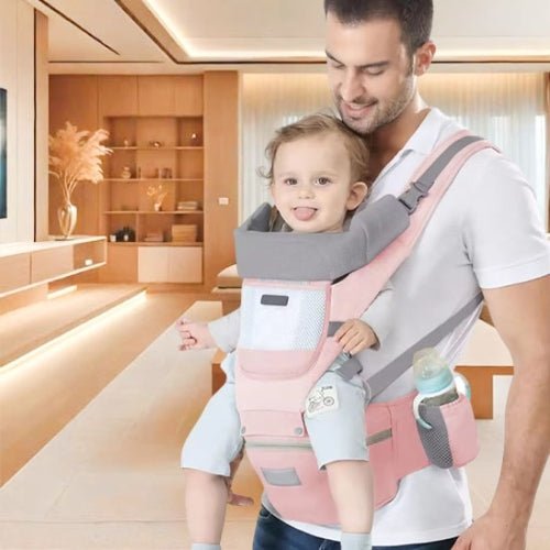 Porte bebe evolutif rose porté en position ventrale avec bébé