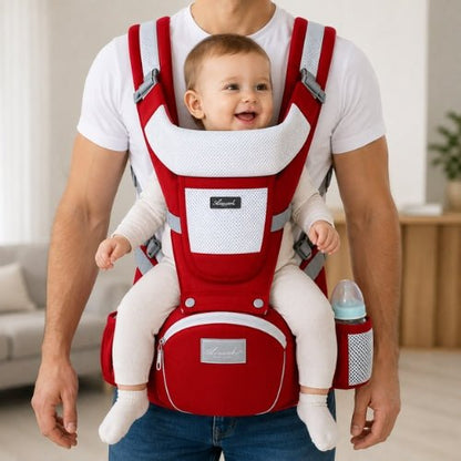 Porte bebe evolutif rouge porté en position ventrale avec bébé