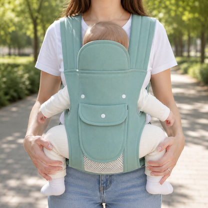 Porte-bébé multiposition vert sauge avec panneau relevable et poche frontale, vue frontale en extérieur