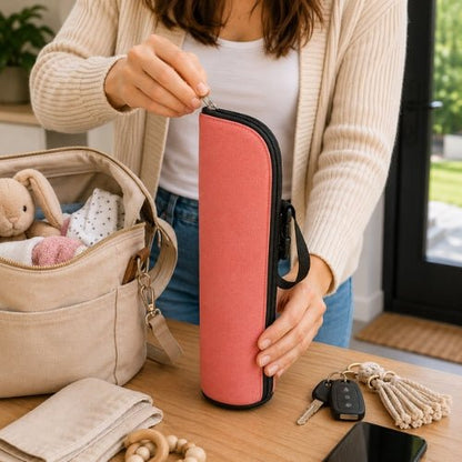 Porte biberon isotherme rose transporté par sa sangle pendant une sortie