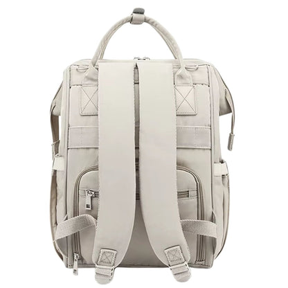 Sac à dos à langer beige vu de dos, sangles matelassées et poches discrètes