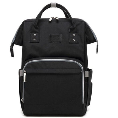 Sac à dos à langer noir présenté de face avec poche frontale zippée visible