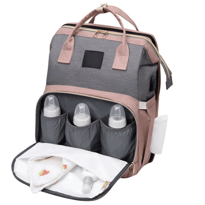 Sac à dos à langer ouvert, montrant trois biberons rangés dans la poche avant