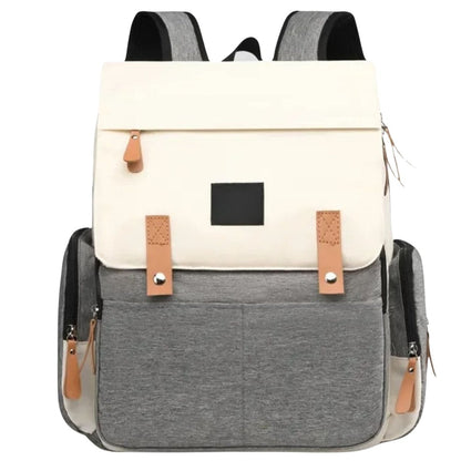 Sac à dos à langer posé en face avec poignée renforcée et format compact