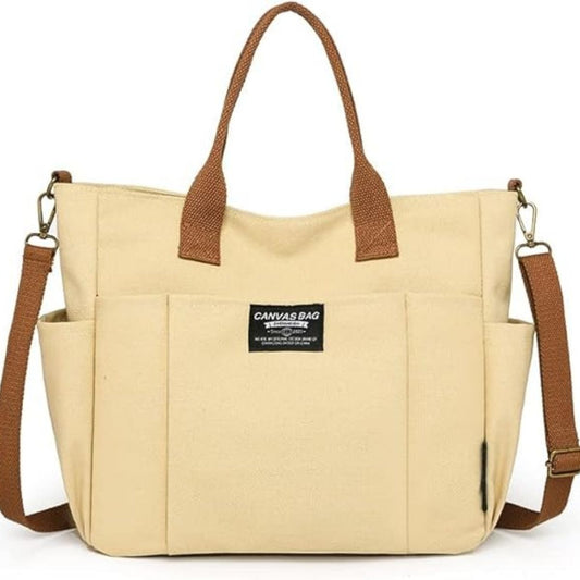 Sac a langer compact kaki en toile rigide avec anses marron et poches latérales visibles