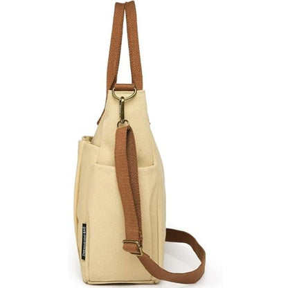 Sac a langer compact kaki vu de côté avec bandoulière réglable et poche latérale pratique