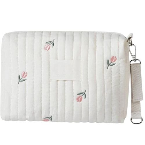 Sac a langer tulipe pose a plat avec anse laterale et broderies visibles sur le tissu matelasse
