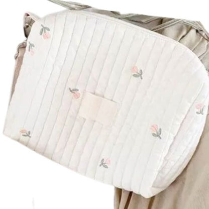 Sac a langer porte en bandouliere au niveau de la taille avec motif tulipe brode