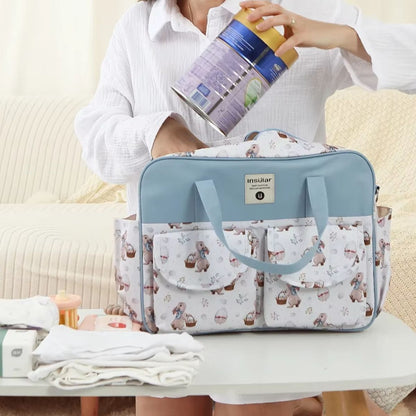 Sac à langer grande capacité Lapin de Pâques utilisé par une maman pour ranger les affaires de bébé en intérieur