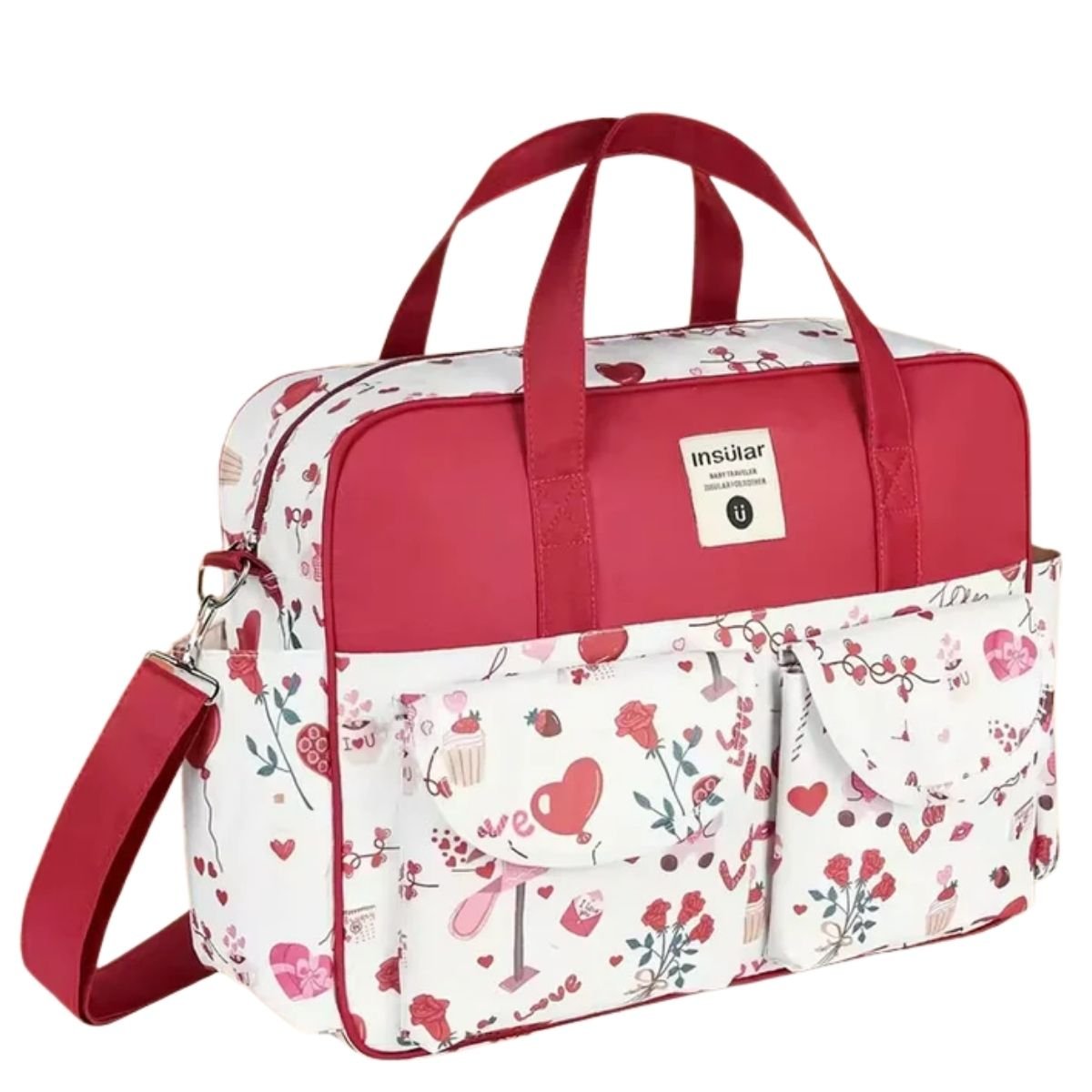 Sac a langer grande capacite rose rouge avec poches avant et bandoulière assortie posé sur une table