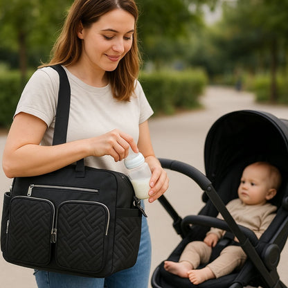 Maman utilisant un sac a langer noir en preparant un biberon pres d une poussette