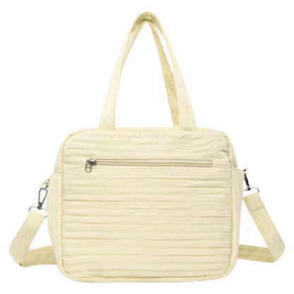 Intérieur du sac a langer avec motif lapin, montrant rangement pour couches et biberon