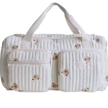 sac a langer creme avec plusieurs petits ours imprimes et poches visibles