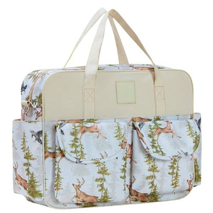 sac bebe motif foret vu de face avec poches à rabat et anses crème