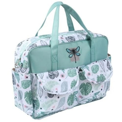 sac pour bebe tropical vert avec poches latérales visibles et tissu imperméable