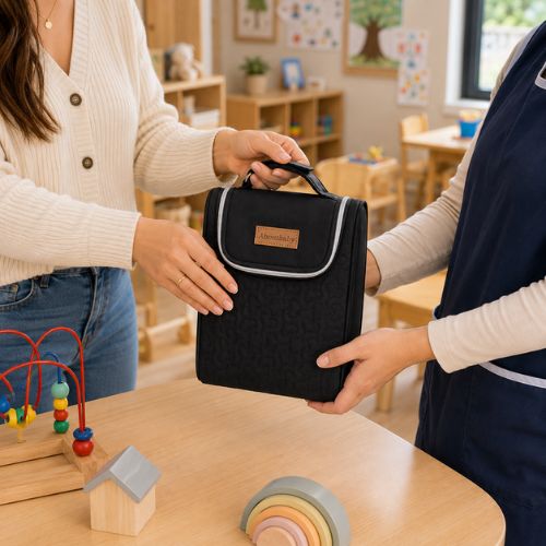 Sac pour deux biberons noir avec poignée intégrée, remis à une professionnelle en crèche