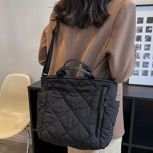 Sac pour maternité noir matelassé porté à l’épaule